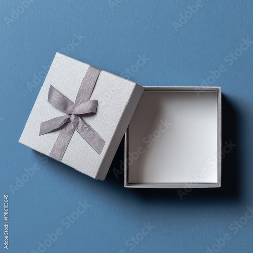 Open Gray Gift Box with Ribbon on Blue Background