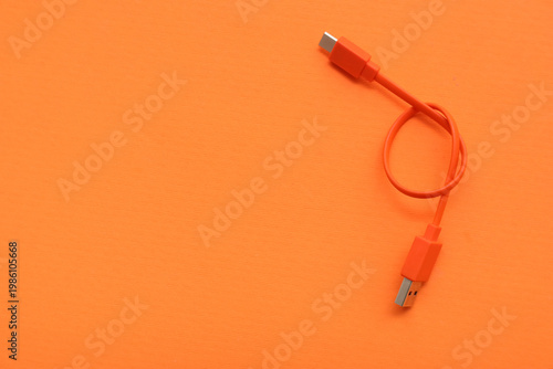 USB cable on orange background