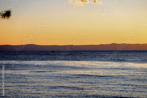 Sea with ship at Makarska on the Riviera at sunset, in Dalmatia in late summer
