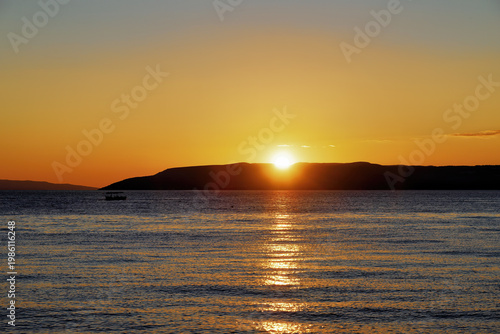 Sea with ship at Makarska on the Riviera at sunset, in Dalmatia in late summer