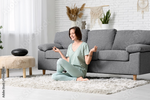 Young woman meditating whil...