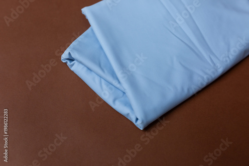 blue knitted fabric on a brown background