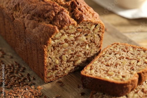 Fresh whole wheat bread with flax seeds on rustic table