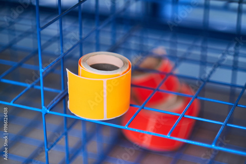 Bright coloured Illuminous adhesive label rolls on an industrial production line in packaging and manufacturing environment. Food labels for health safety and hygiene purposes.