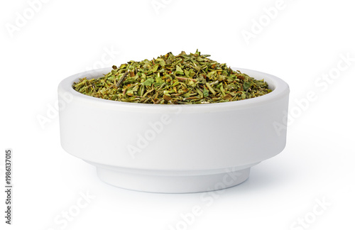 Dried oregano spice in white bowl for seasoning