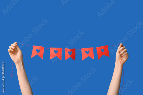 Woman holding red paper gar...