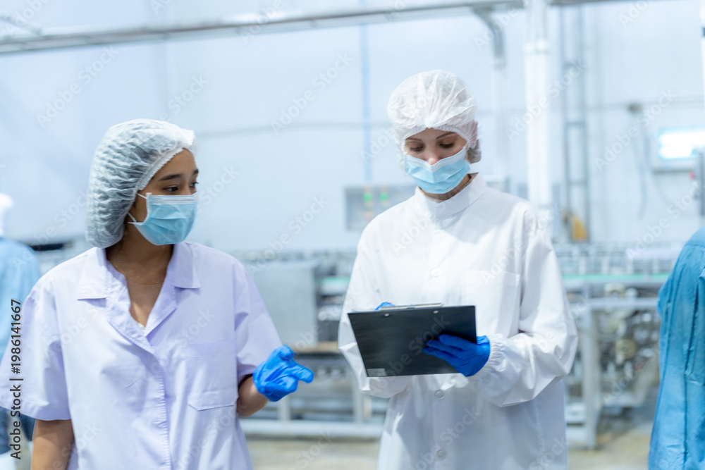 Naklejka premium Food and manufacturing researchers oversee seafood production lines in tightly controlled factories where machinery is used to produce and cook food before it is shipped out.