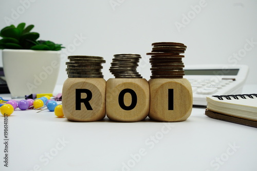 Bilde på lerret Stack of coins with wood blocks with ROI (Return on Investment) Financial conc