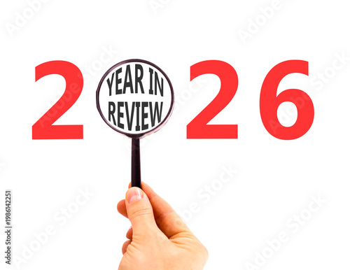 2026 year in review symbol. Concept words 2026 year in review in beautiful magnifying glass. Beautiful white background. Businessman's hand. Business 2026 year in review concept. Copy space.