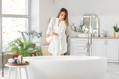 Beautiful woman pouring mil...