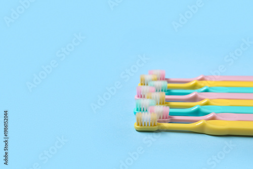 Colorful toothbrushes on bl...