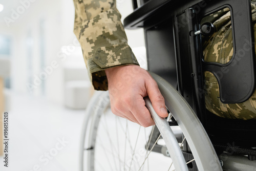 Quadro em tela Close up of unrecognizable man in military uniform sitting in wheelchair in hosp