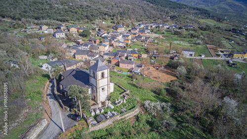 Aerial view from the church of Our Lady of the Assumption that crowns the town of San Juan de Paluezas above a barbican and a small cemetery next to the bell tower