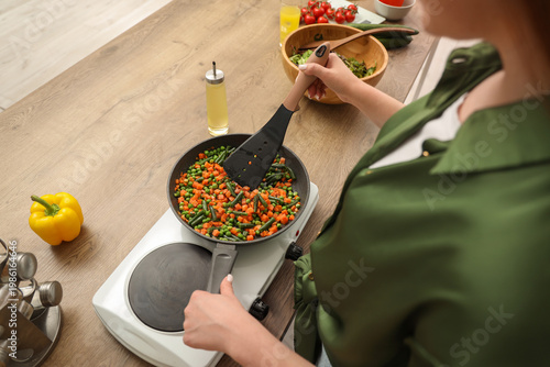 Woman cooking mixed vegetab...