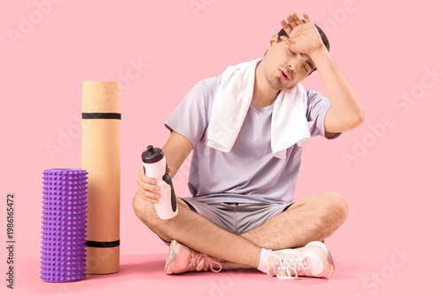 Tired young man with bottle...