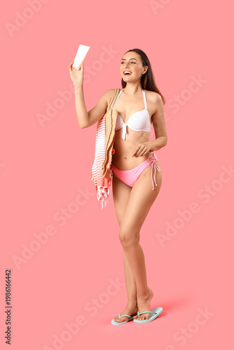 Young woman with sunscreen ...