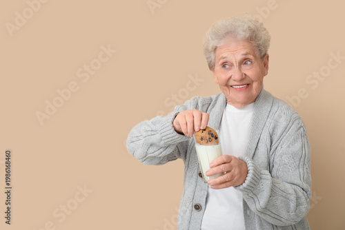 Senior woman with glass of ...