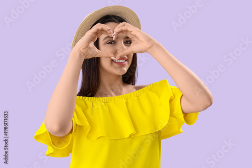 Young woman making heart wi...