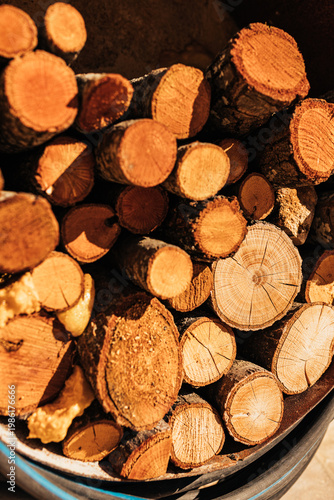 Stacked firewood logs forming natural wood texture background