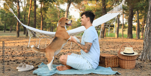 Young man with Beagle dog a...