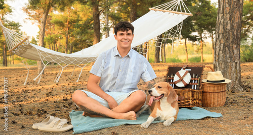 Young man with Beagle dog a...