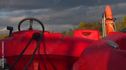 a red boat on the river in a city park