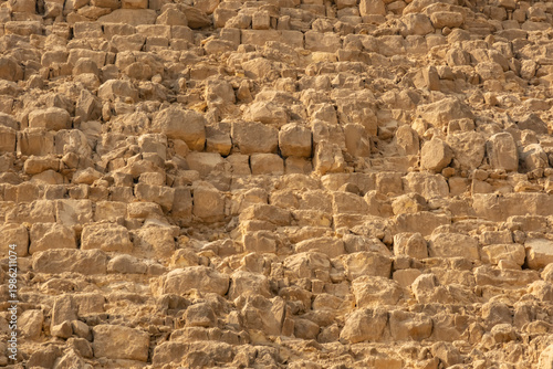 Exploring the structure and details of ancient stones at the Great Pyramid in Egypt during the daytime hours