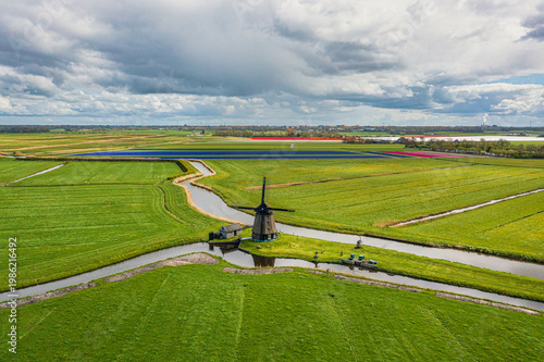 A bird's-eye view of a landscape in North Holland with a typical windmill.