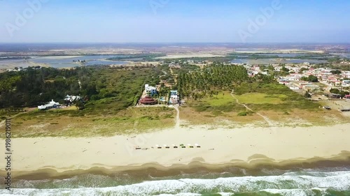Aerial Pullback Revealing Tropical Beach Shoreline and Coastal Town
