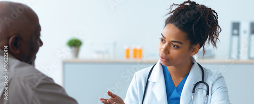 Photos A doctor speaks with a patient in a medical office