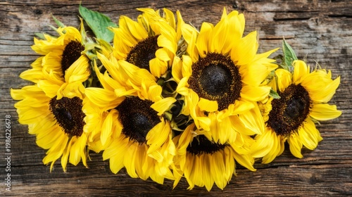 sunflowers. Sunflowers arranged on a rustic wooden surface, vibrant yellow pe...