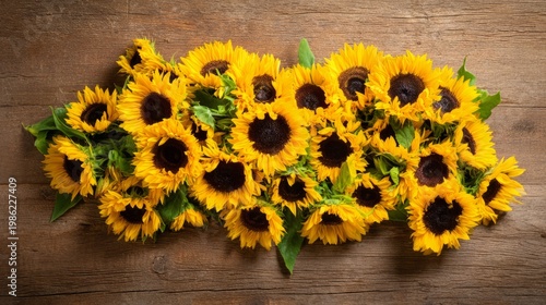 sunflowers. Sunflowers arranged on a rustic wooden surface, vibrant yellow petals with dark centers in soft light. event programs.
