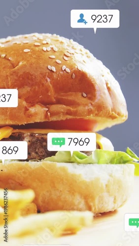 Vertical video: Burger being revealed by pan down, badges popping, counting then fading for ads
