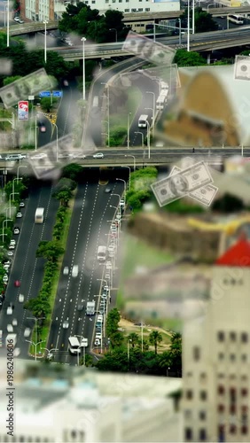 Vertical video: Aerial highway starting cash overlay, falling bills sweeping lanes, showing finance