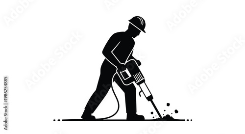 Silhouette of a construction worker operating a jackhammer on the ground