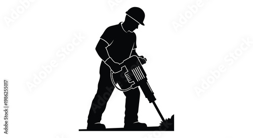 Silhouette of a construction worker operating a jackhammer on concrete