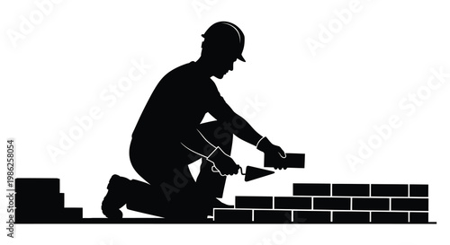 Silhouette of a bricklayer working on a wall construction project