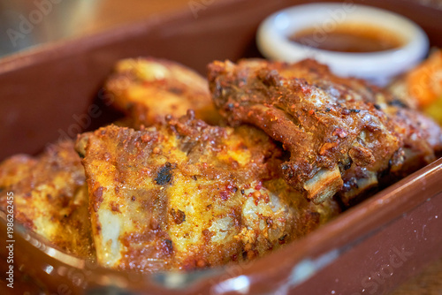 Pork ribs with barbecue sauce and pickles in the restaurant   