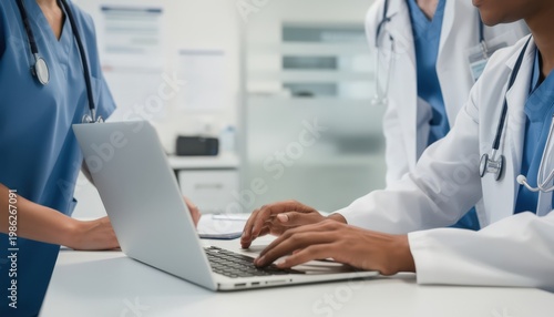 Medical staff using a digital portal on a laptop with the foreground in sharp focus and the background out of focus illustrating electronic prior authorization evaluation.
