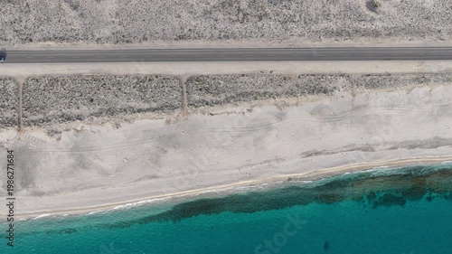 Car driving on a coastal highway with nice beach in Spain (Cabo de Gata, Andalusia)