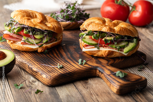 Homemade croissant sandwiches filled with fresh ingredients, ready for eating.