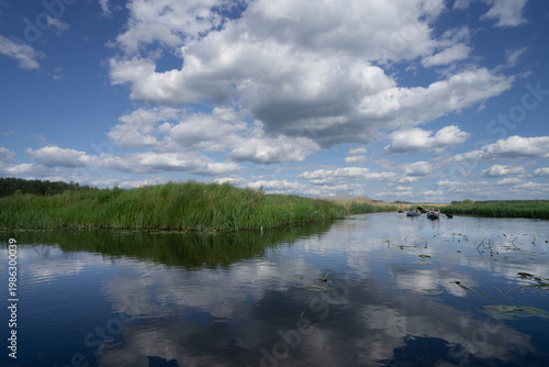 Calm River with Reflections and Kayakers in Nature