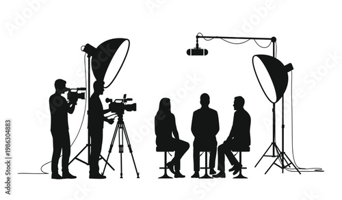 A black and white image depicts a television interview setup with a camera operator three guests and studio lighting presented as a silhouette