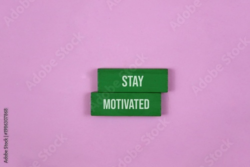 Fotografie Stay Motivated Sign On pink Background With Green Blocks And Positive Message Fo