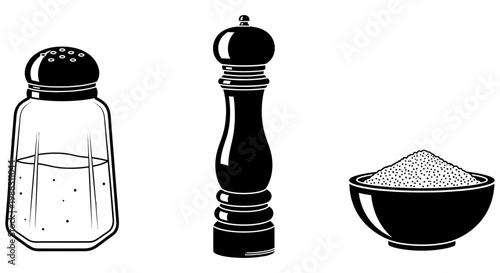 Salt shaker pepper mill and small bowl of ground spice