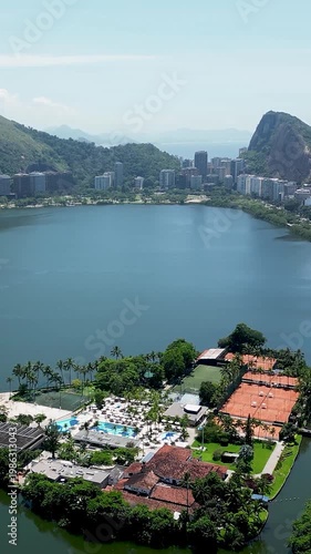 Rodrigo De Freitas Lake At Downtown City Rio De Janeiro Brazil. Aerial View Of A River Surrounded By Lush Green Tropical Rainforest. Construction Skyline High Rise Building Awesome.
