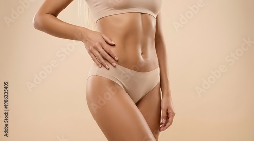 A clean studio shot of a young blonde tanned woman in minimal inner wear