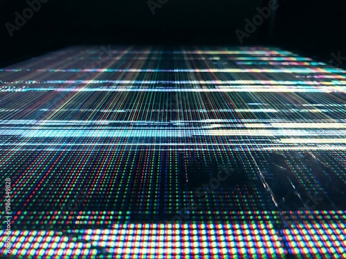 IA generated, extreme macro photography of a digital screen display showing a vibrant grid of RGB pixels and sub-pixels creating a technical textured pattern with multicolored light dots.