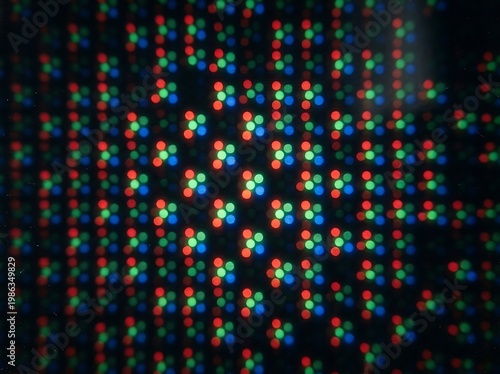 IA generated, extreme macro photography of a digital screen display showing a vibrant grid of RGB pixels and sub-pixels creating a technical textured pattern with multicolored light dots.