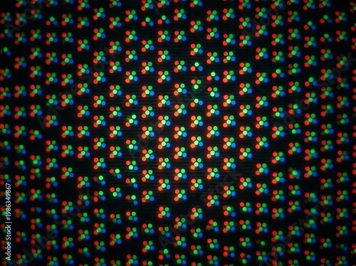 IA generated, extreme macro photography of a digital screen display showing a vibrant grid of RGB pixels and sub-pixels creating a technical textured pattern with multicolored light dots.